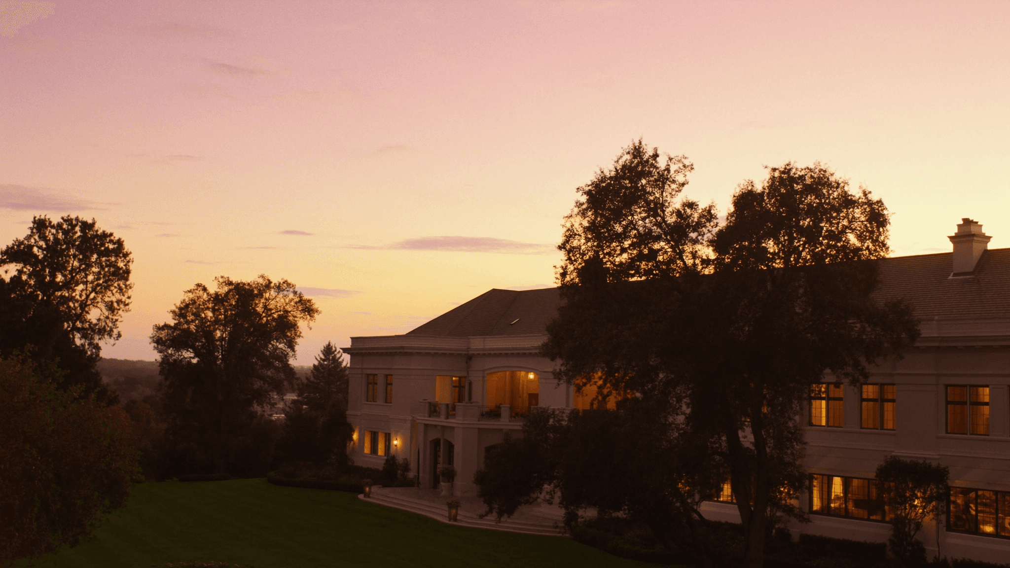 A grand Wisconsin estate glowing at golden-hour sunset
